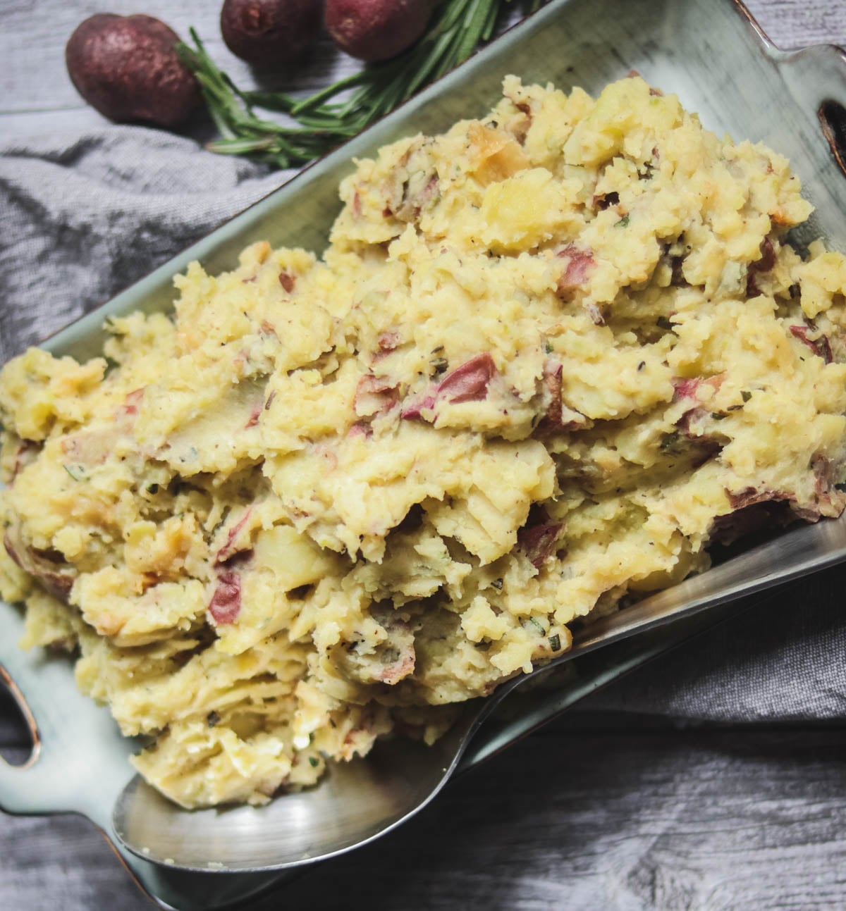 roasted garlic mashed potatoes with a silver spoon.