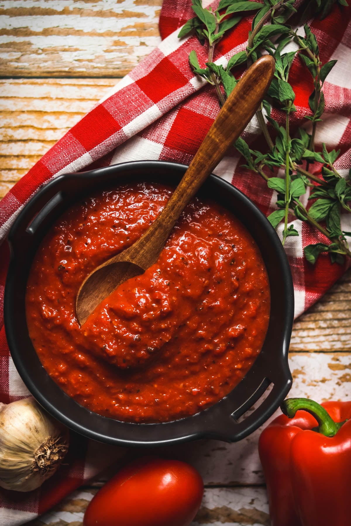 Bowl of Tomato and Red pepper Sauce sitting on a red and white napkin.