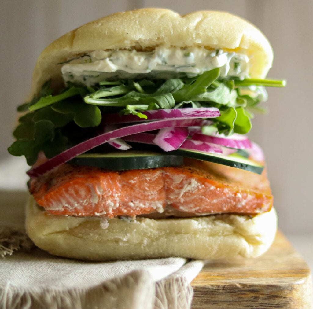 Closeup photo of a baked salmon sandwich.