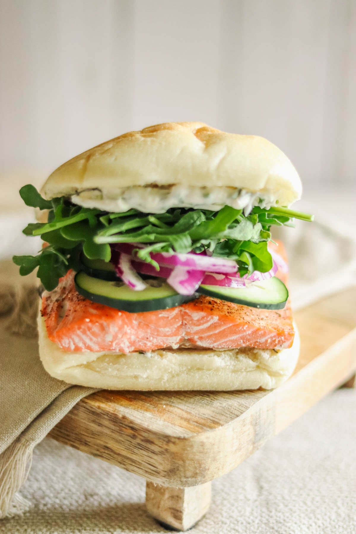 Salmon Sandwich with a beige napkin.