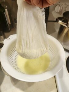 Cheesecloth full of curds.