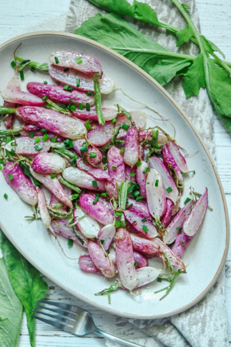 Plate of radishes that have been roasted.