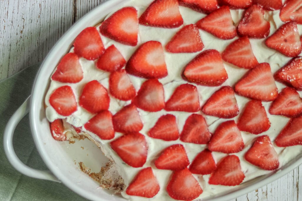 Strawberry tiramisu in an oval casserole dish.