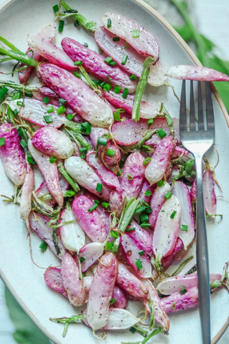 Roasted radishes on a white plate.