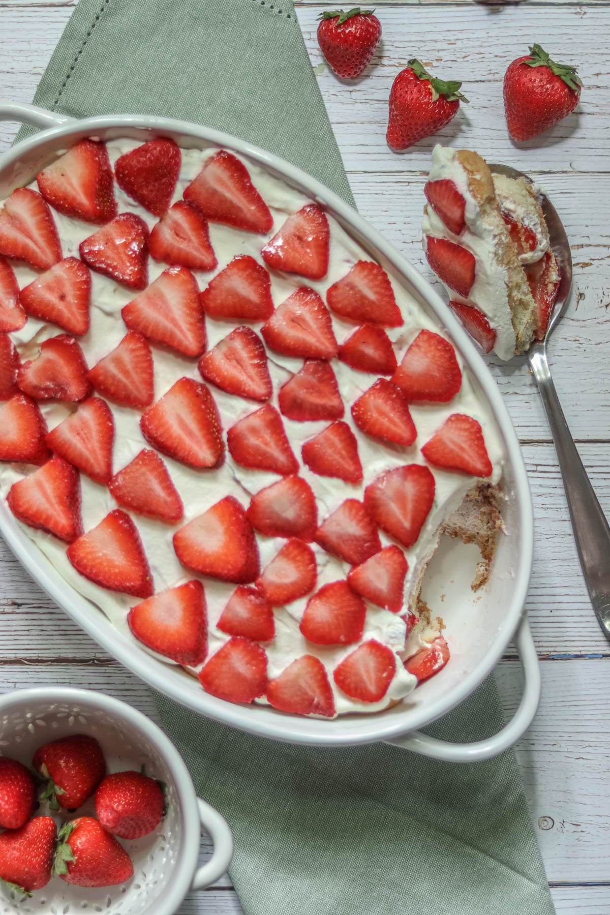 Strawberry Tiramisu nest to a bowl of strawberries.