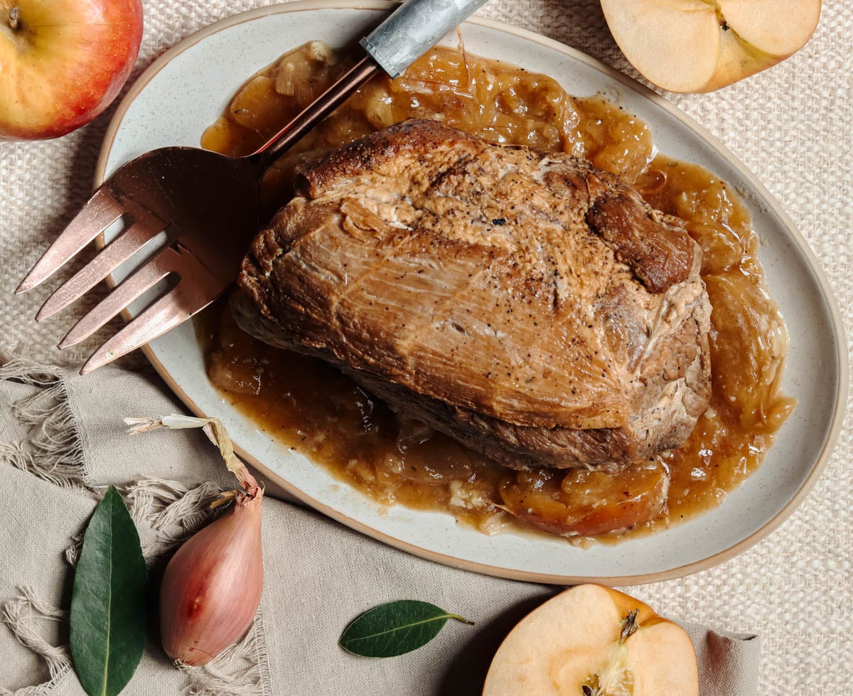 Apple Cider Braised pork Roast on a white platter.