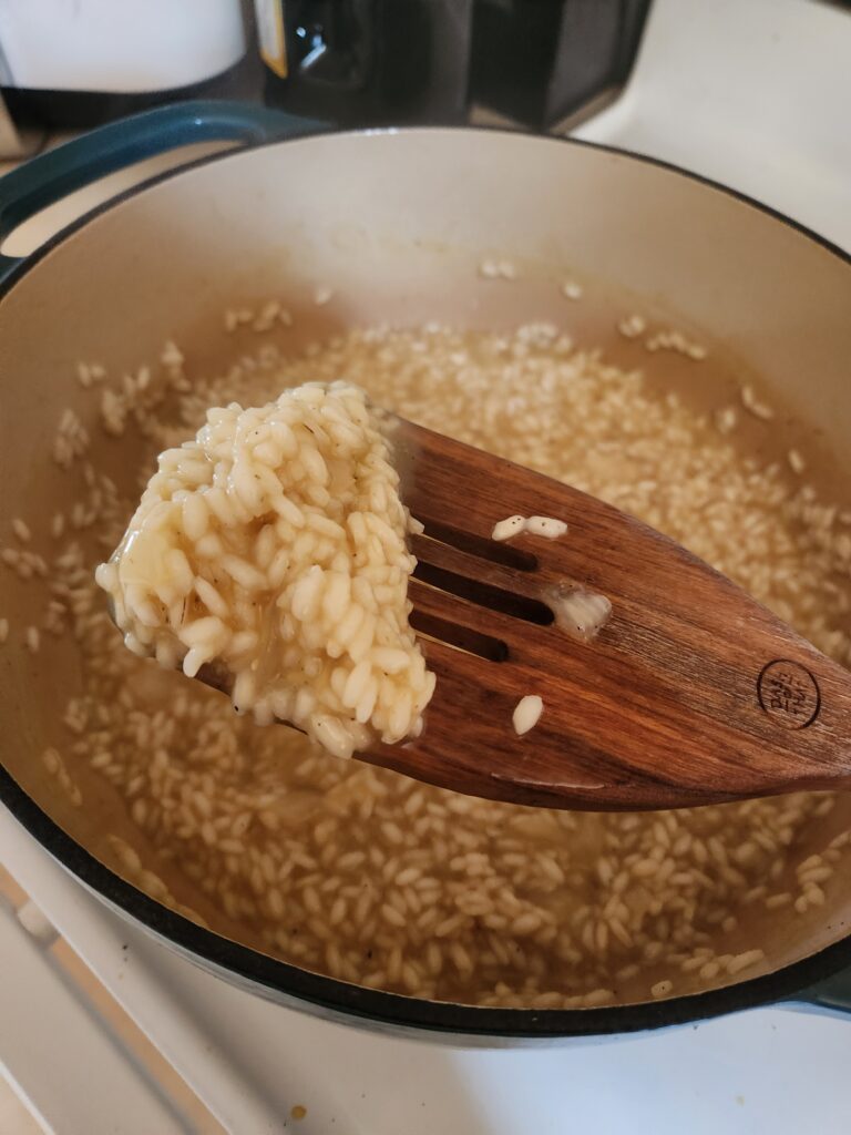 Risotto on a wooden spatula.