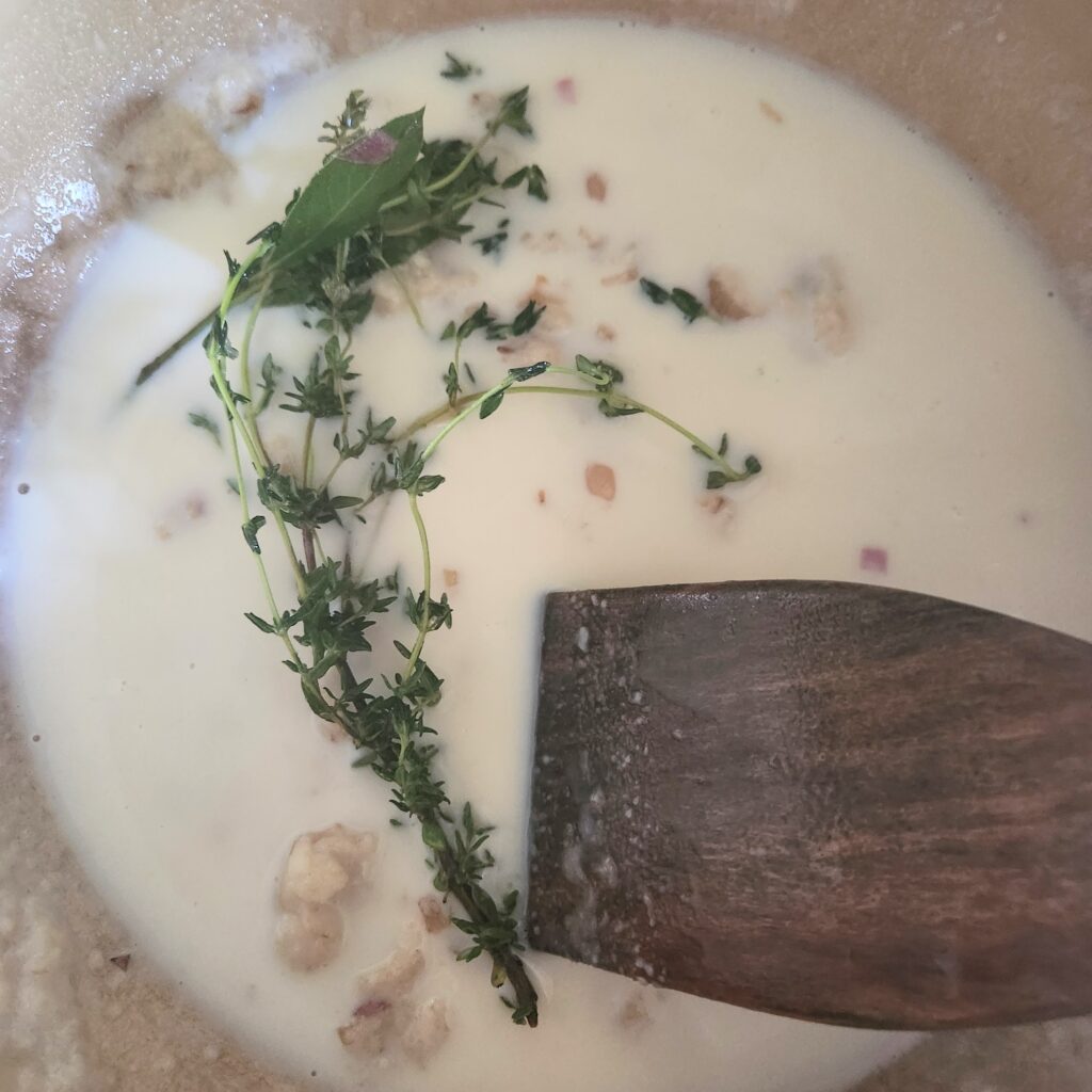 Add milk to the pot to make the sauce.