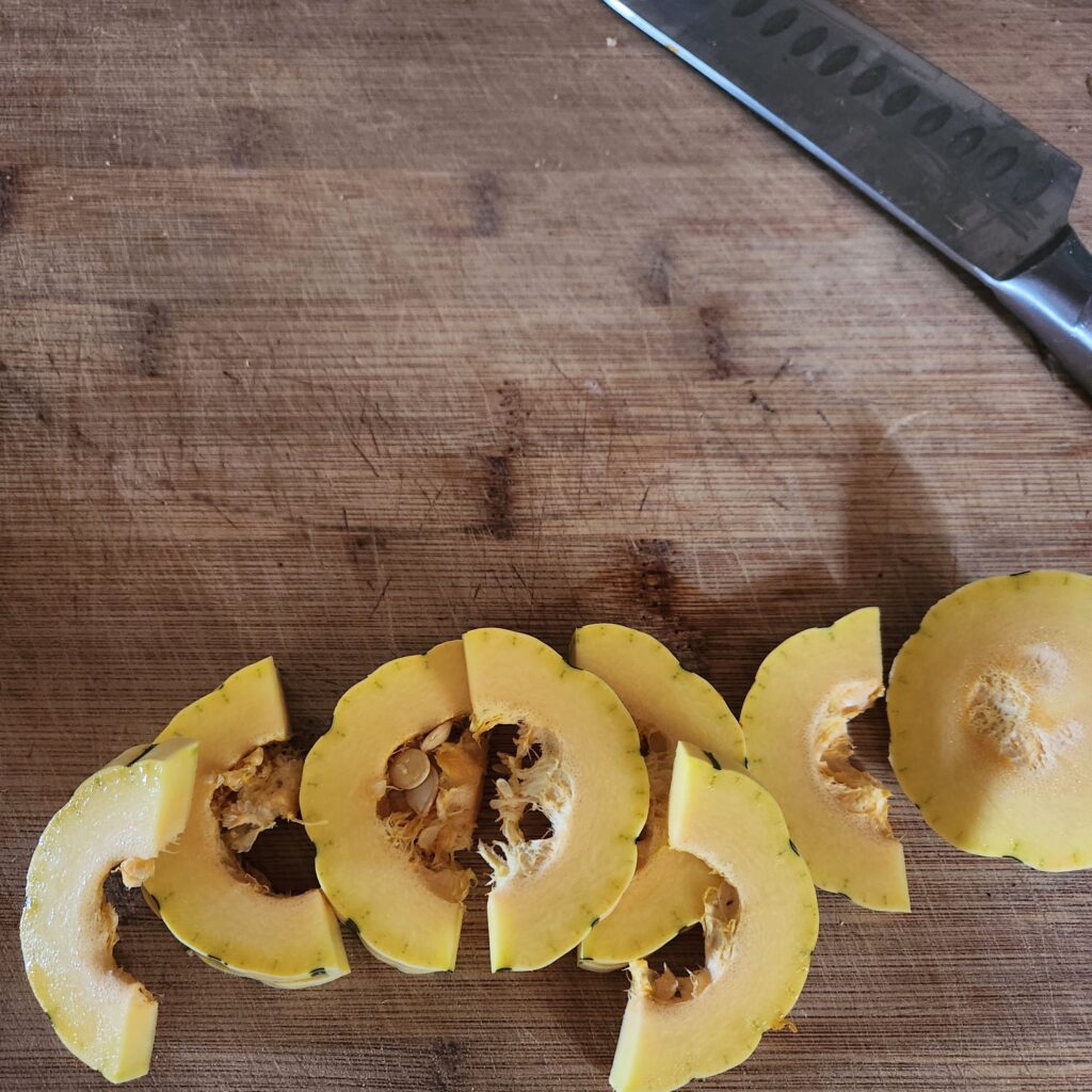 Slicing delicata squash into rings.