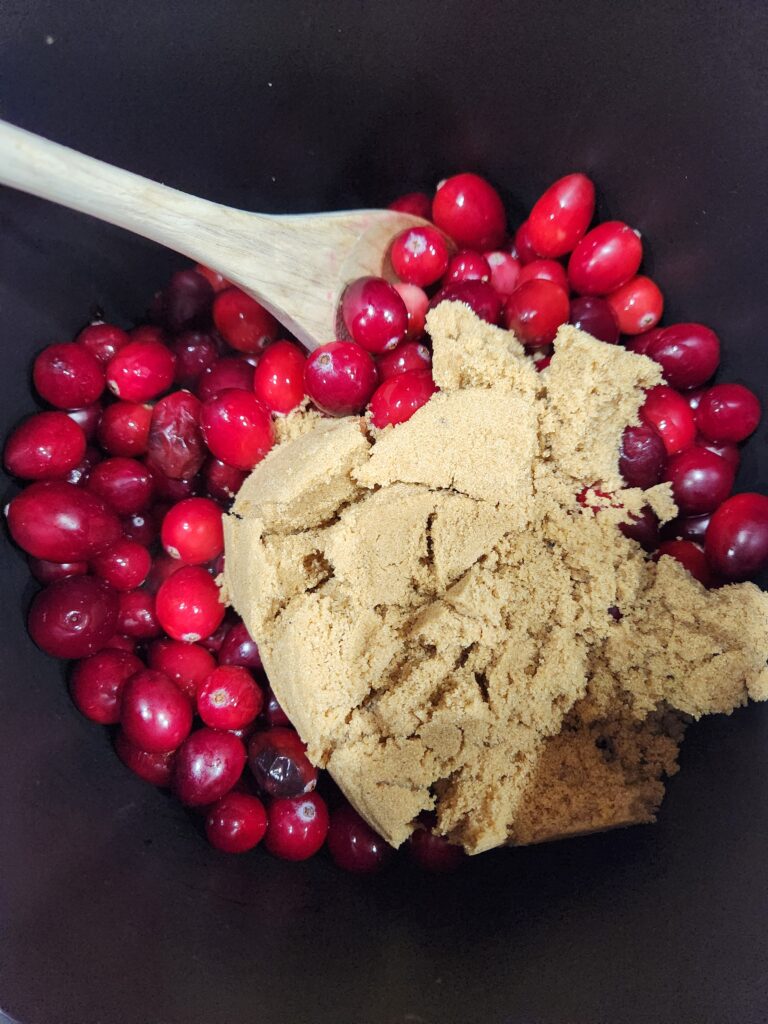 Cranberries and sugar in a saucepan.