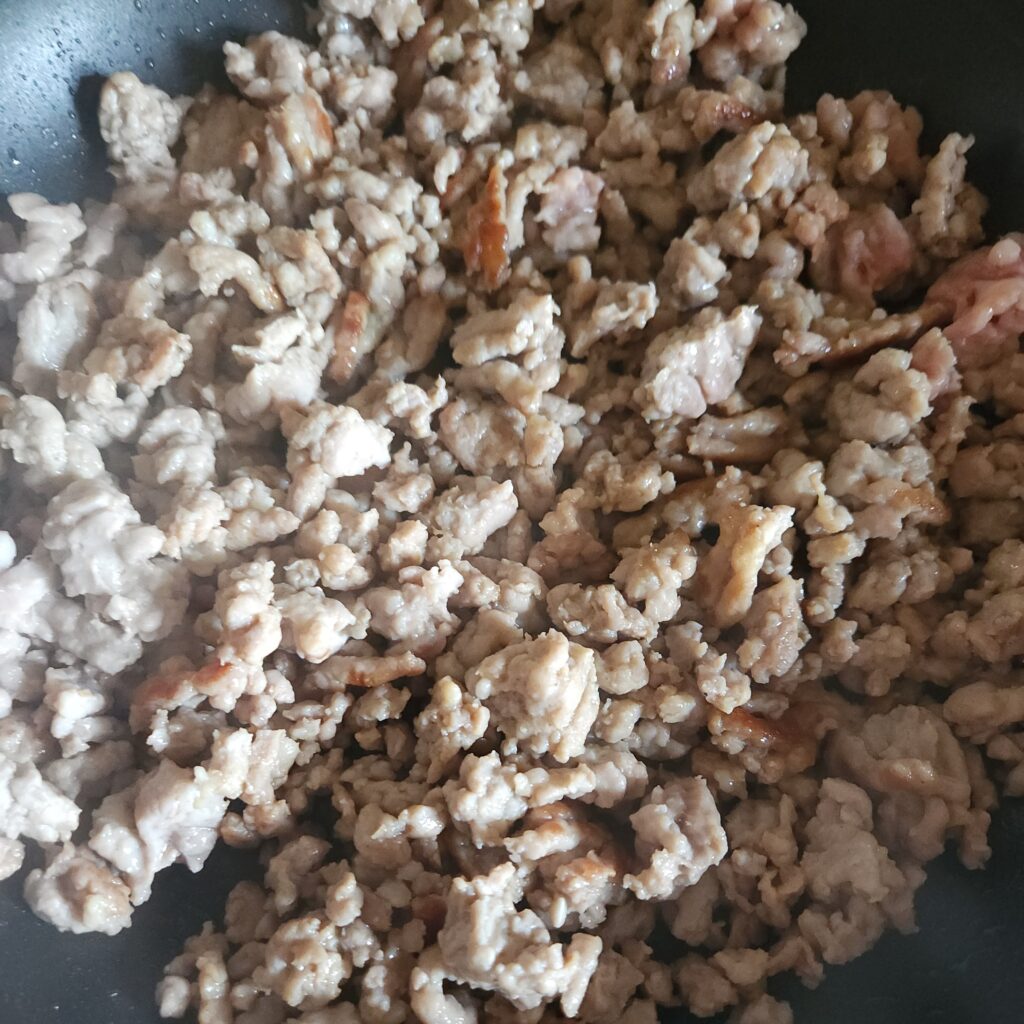 Sausage browning in a skillet.