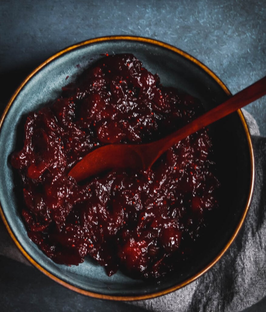 Cranberry sauce with jalapeno in a blue bowl.