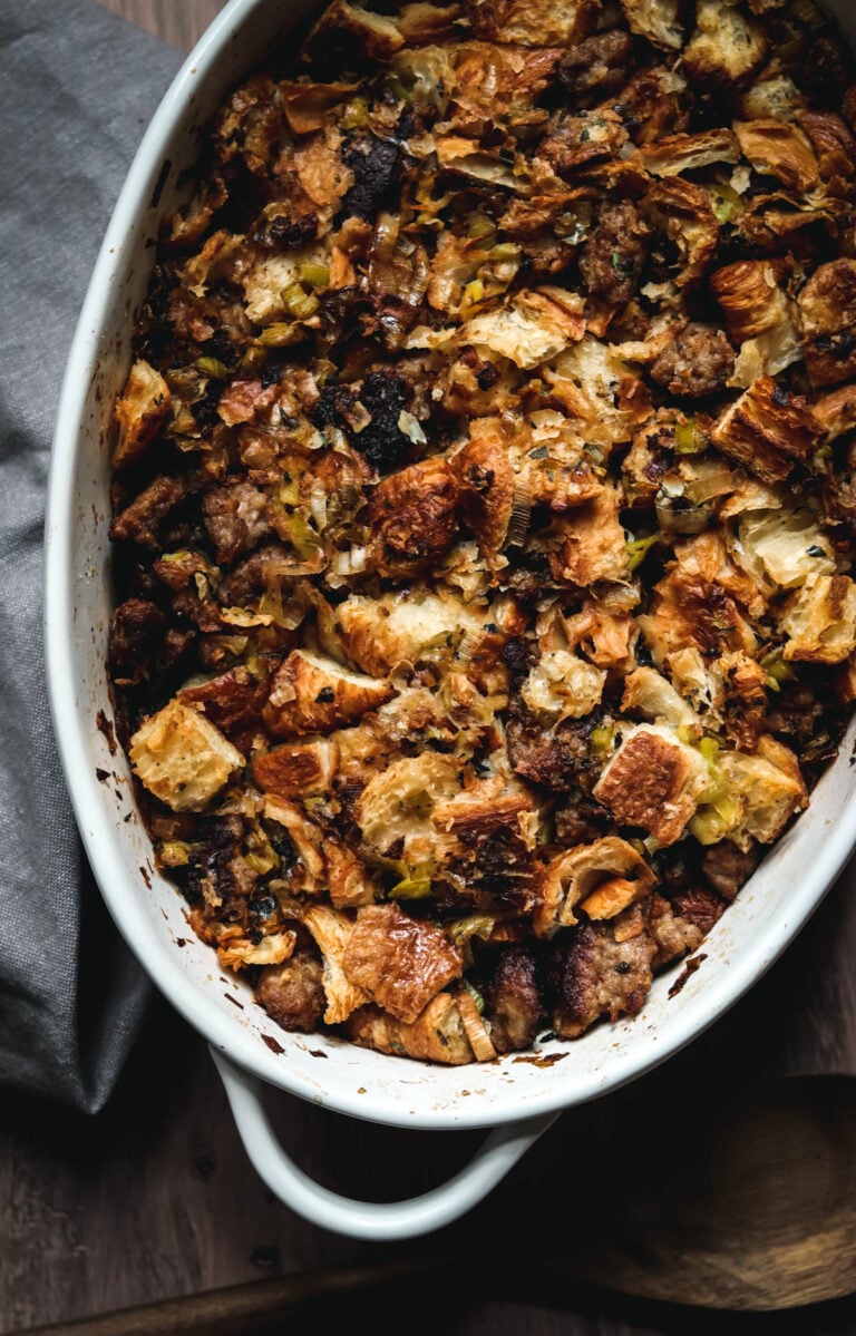 Oval shaped dish of stuffing made from croissants.