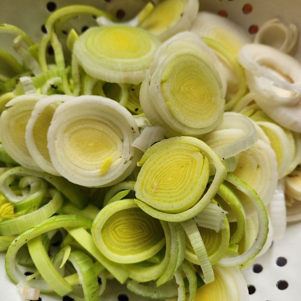 Leeks in a strainer.