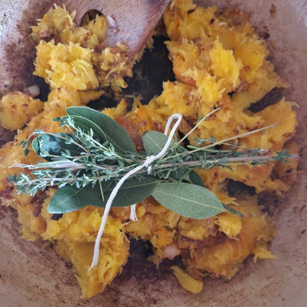 Squash and herbs in the pot.