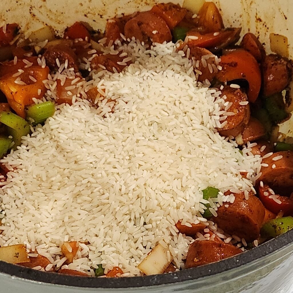 Adding the rice to the pot.