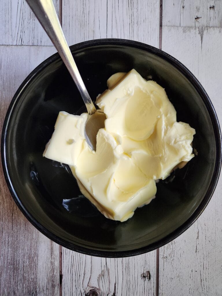 Adding salt to the compound butter.