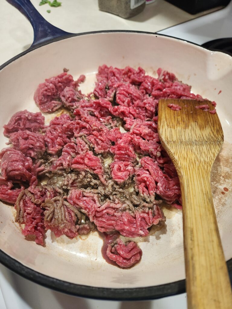Beef browning in a skillet.